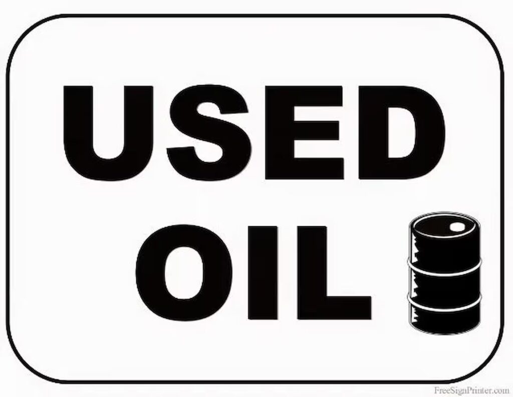 A sign that says, "Used Oil" with a barrel icon