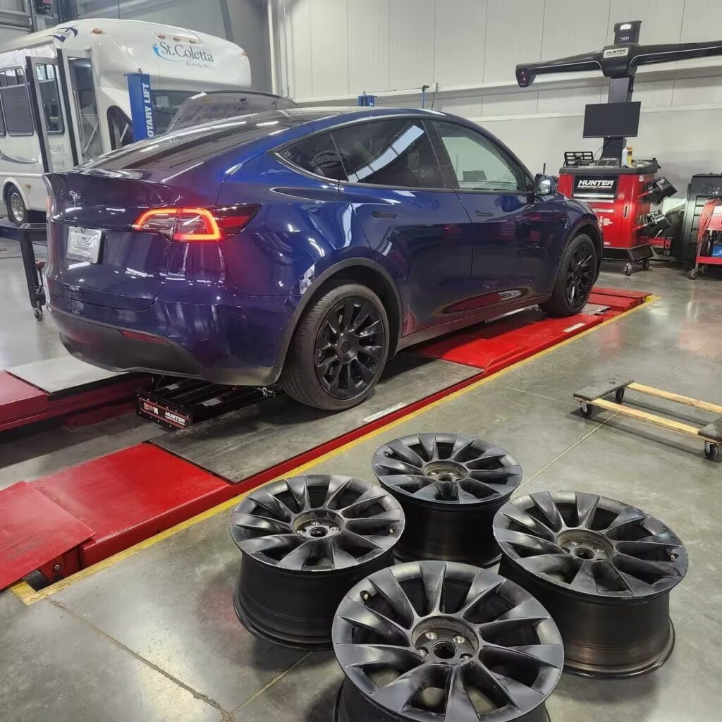 a blue car on a car port in an auto repair setting
